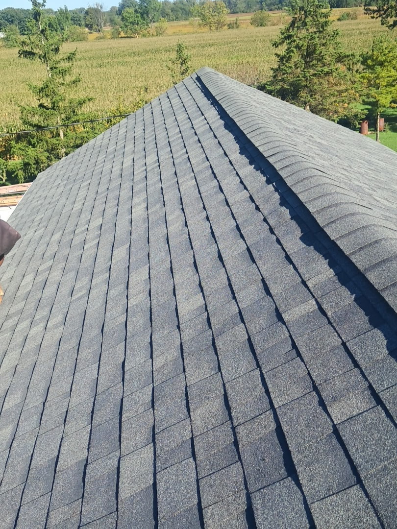 Gray asphalt shingle roof with matching ridge caps