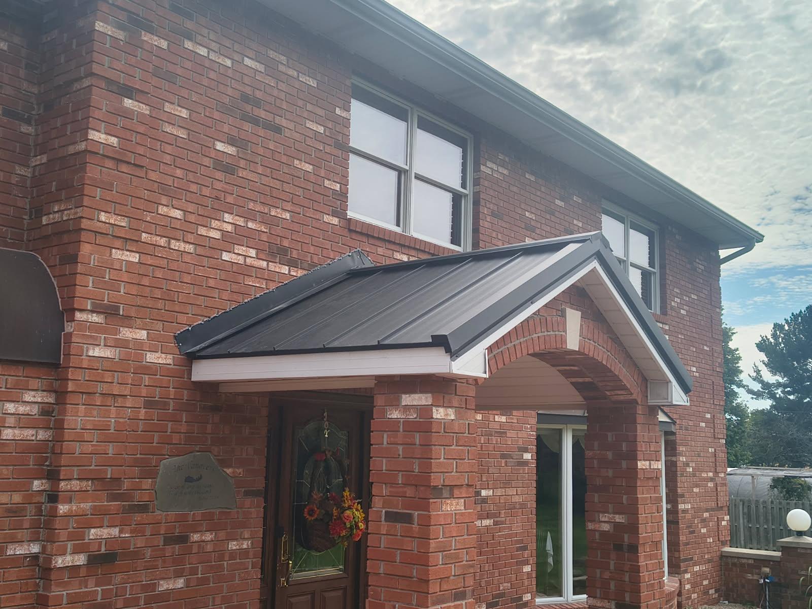 Standing-seam roof on a brick porch