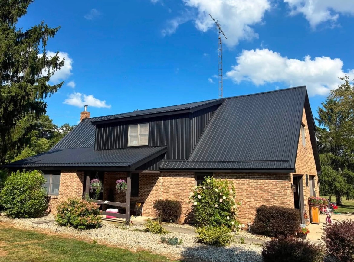 Brick home with a dark metal roof