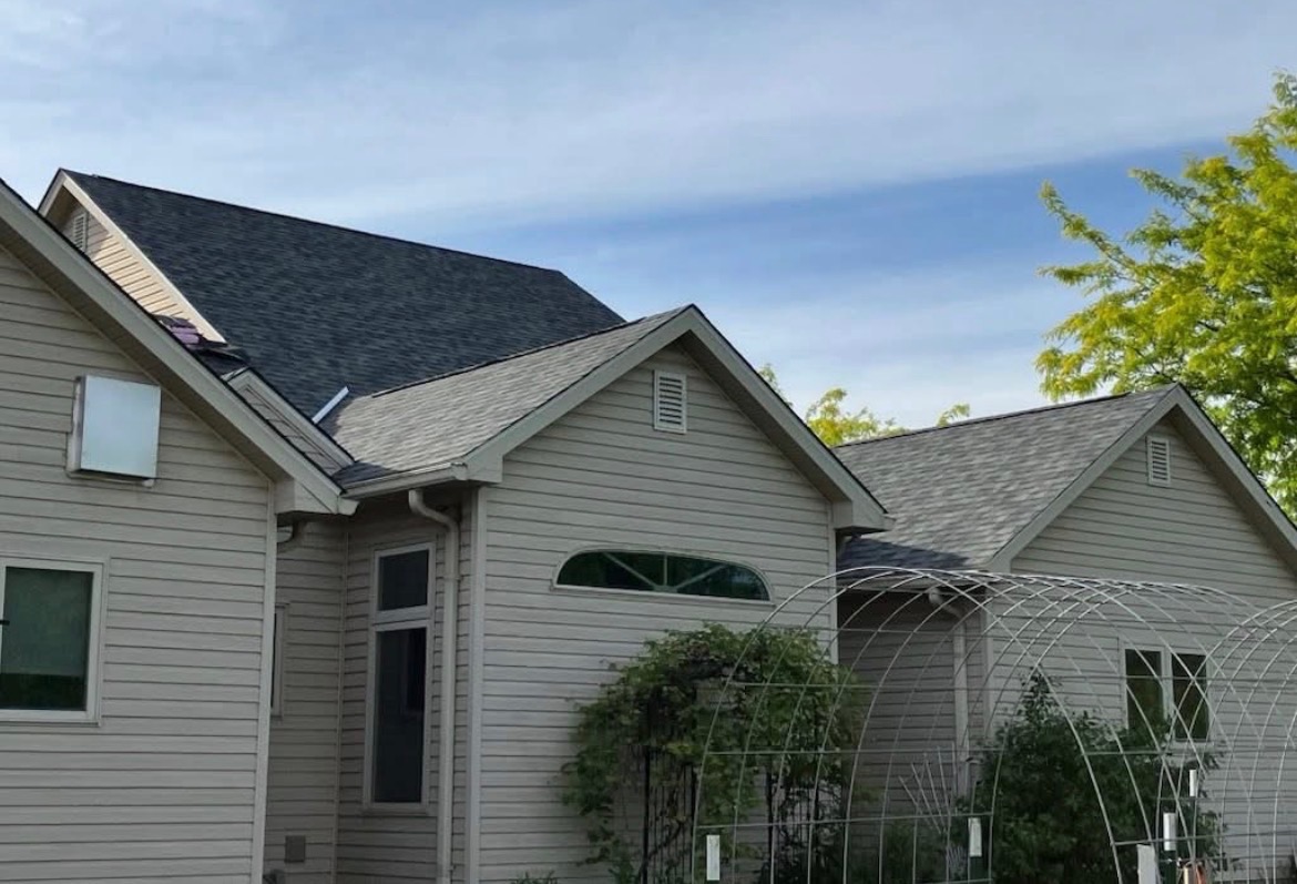 Gray asphalt shingle roof on a light-colored home